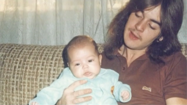 young Ryan holding baby