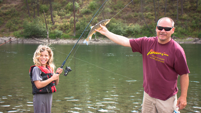 Camp Director with little girl who caught a fish