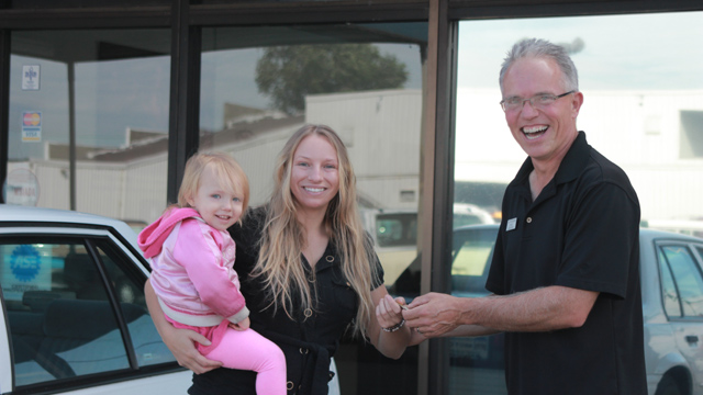 Curt handing keys of car to lady