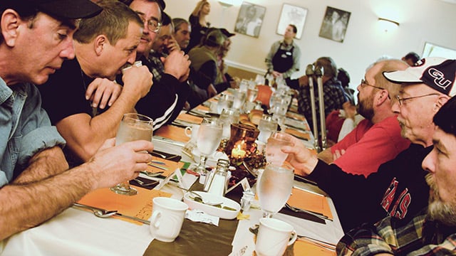 men eating at a table