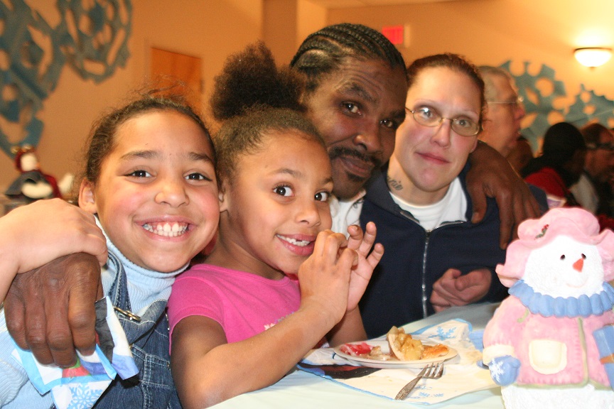 homeless family eating at shelter