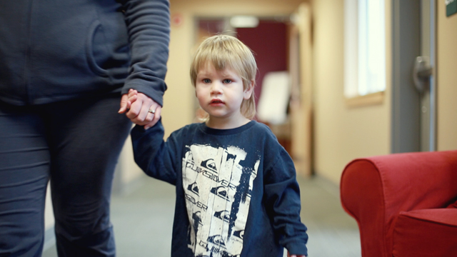 child holding mom's hand