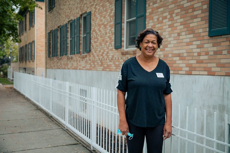 Anita standing outside AOH present day