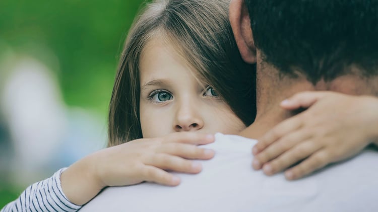 girl looking over fathers shoulder-blog