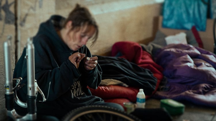 homeless woman preparing drugs