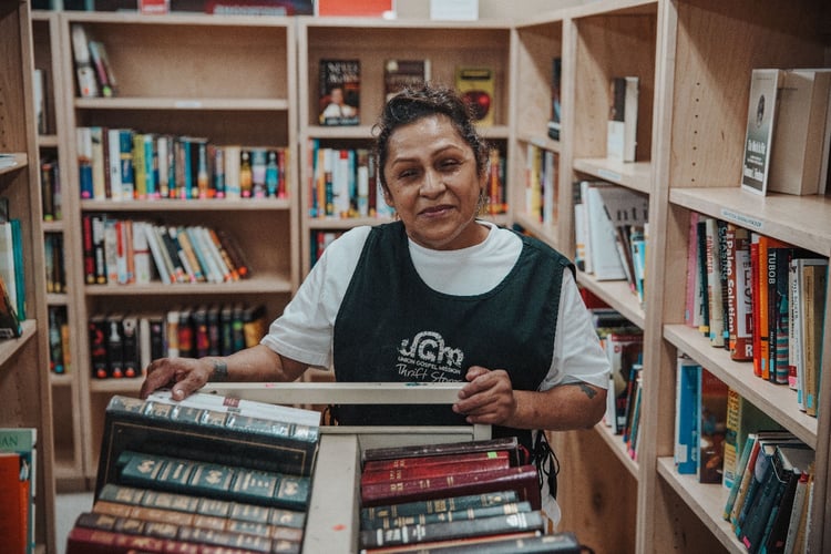 Kathy sorting books at the Valley Thrift Store