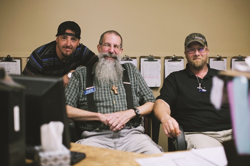 Jon, shown with UGM residents Adam and Mark, wanted to help the homeless but didn't know how. He came to volunteer at UGM.