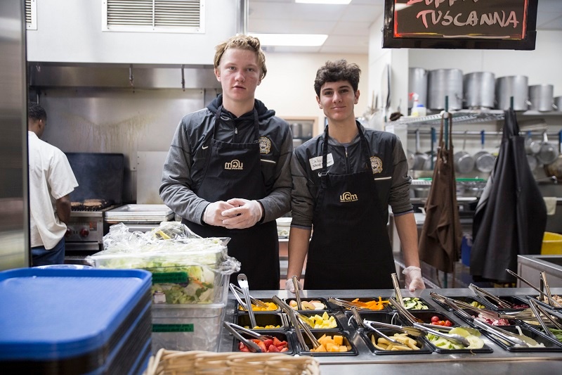 Meal servers help to feed the hungry at UGM and offer them a smile.