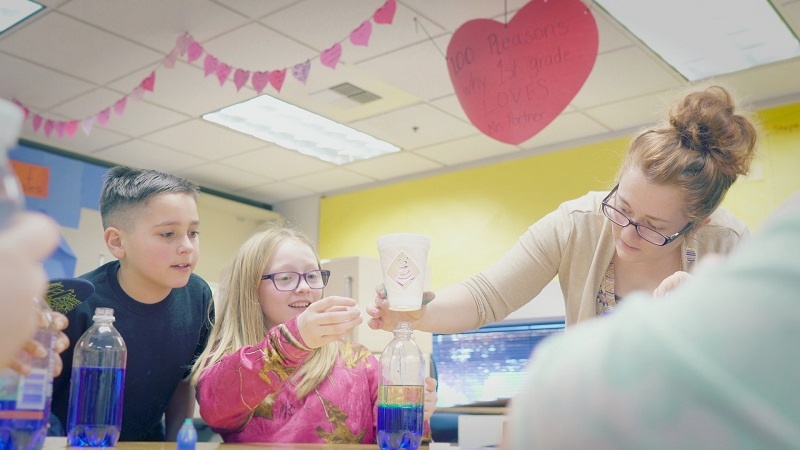 Meredith helps Stevens Elementary students with a project after school at Young Club.