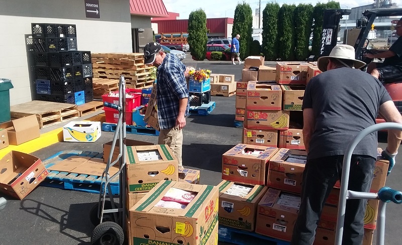 UGM warehouse crew includes residents, volunteers, and staff. All hands were on deck to sort the donations from Wal-Mart, one of UGM's food partners.