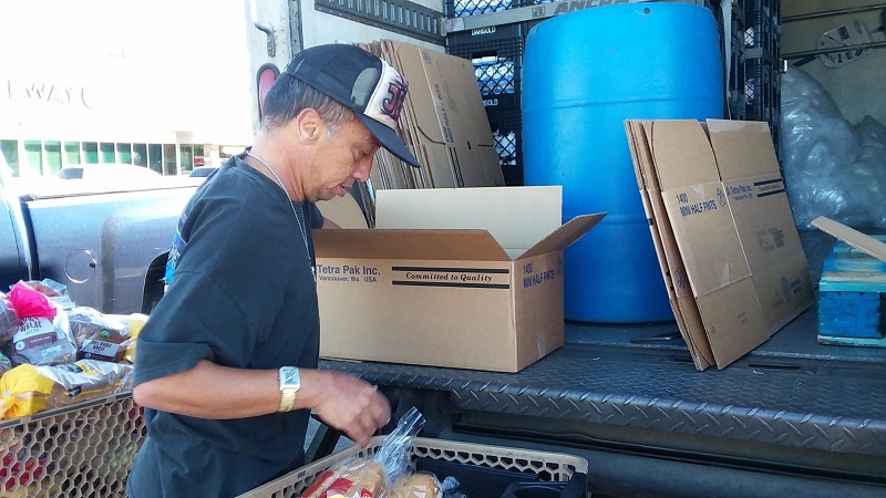 Rick sorts bakery donations from Safeway, one of UGM's food partners.