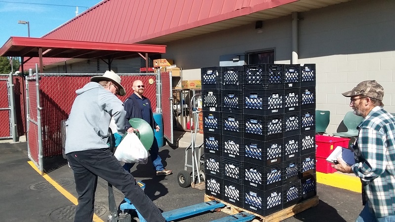 Blake and others on the warehouse crew help move the milk donations into the refrigerators after it was donated by Darigold, one of UGM's food partners.