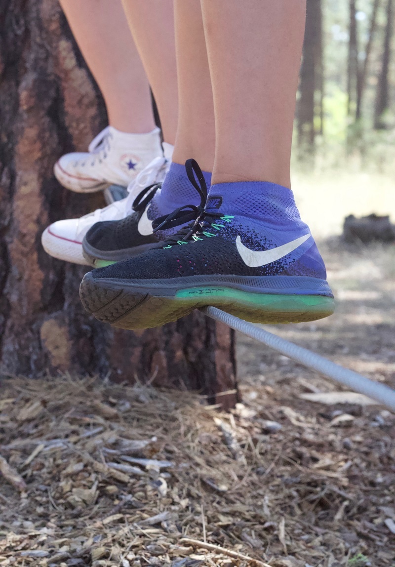 One of the low-ropes challenges at UGM Camp is balancing on "the wire."