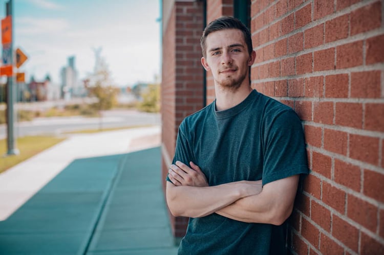 Tyler on a brick wall