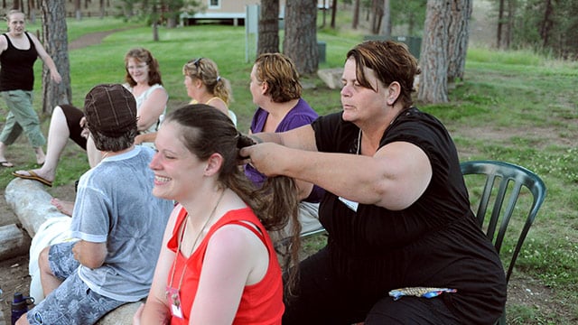 CWC woman braiding another resident's hair
